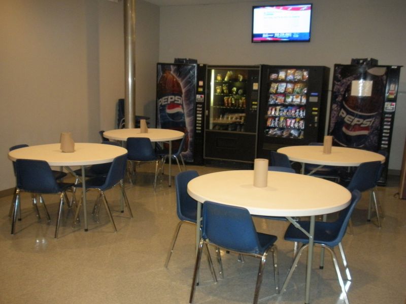 Break room with tables and chairs and food at American Customer Care Montoursville