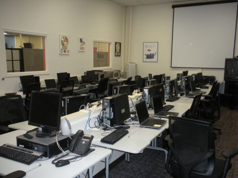 Training room with desks, chairs, computers and phones at American Customer Care Montoursville